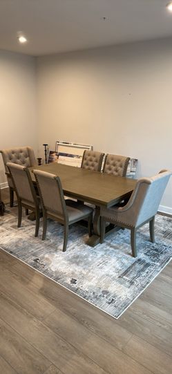 Dining Room Table with Six Studded Chairs and Accent Rug