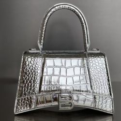 Balenciaga metallic-gloss silver-buckle crocodile leather handbag.