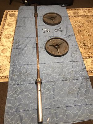 Photo OLYMPIC BAR is 7.4”ft LONG with SET of PLATES 35 LBS EACH TOTAL of 70 LBS