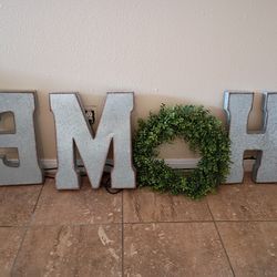 Metal signs that spells out "HOME"