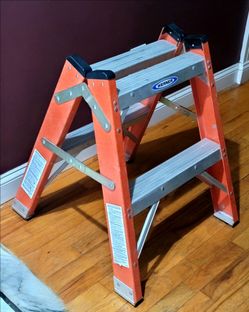Werner T6202 2-foot fiberglass twin step ladder, boasting a 300 lb load capacity per side.