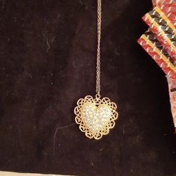 Heart Pendant with clear stones surrounded by a filigree border. 