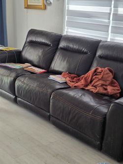 Dark brown leather sofa  two seat lift your feet is in good condition