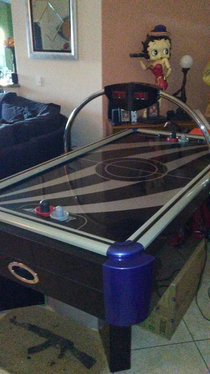 Air hockey table for a game room keeps up scores it talks when you hit the score