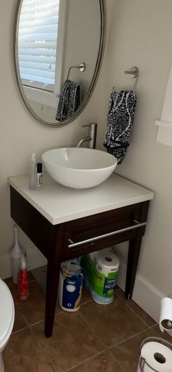 Powder vanity with sink, countertop and faucet.