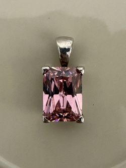 a pink rectangular gemstone pendant set in a four-prong sterling silver basket setting