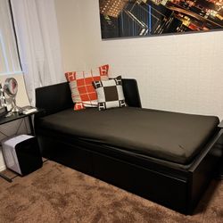 Black twin size bed with two storage drawers, and added twin size bed