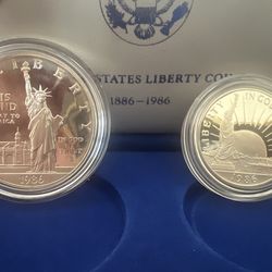 Two silver dollars (1986 liberty silver set )(1977 Canadian Silver Dollar coin, which commemorates Queen Elizabeth II's Silver Jubilee.