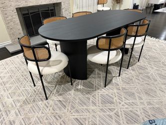 Black oval dining table & rattan/boucle dining chairs