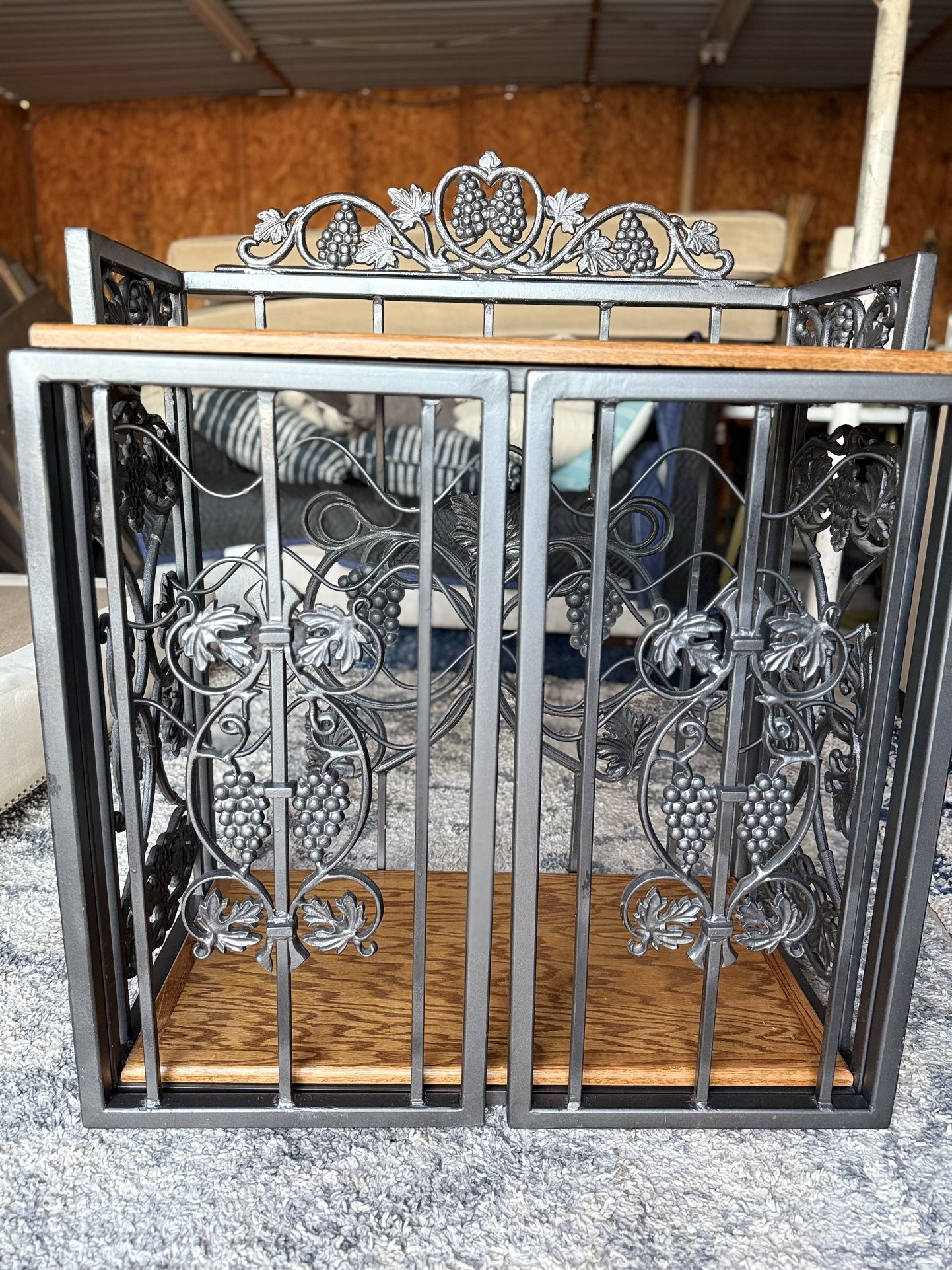 decorative wine rack or wine cabinet with a grape and vine motif. 