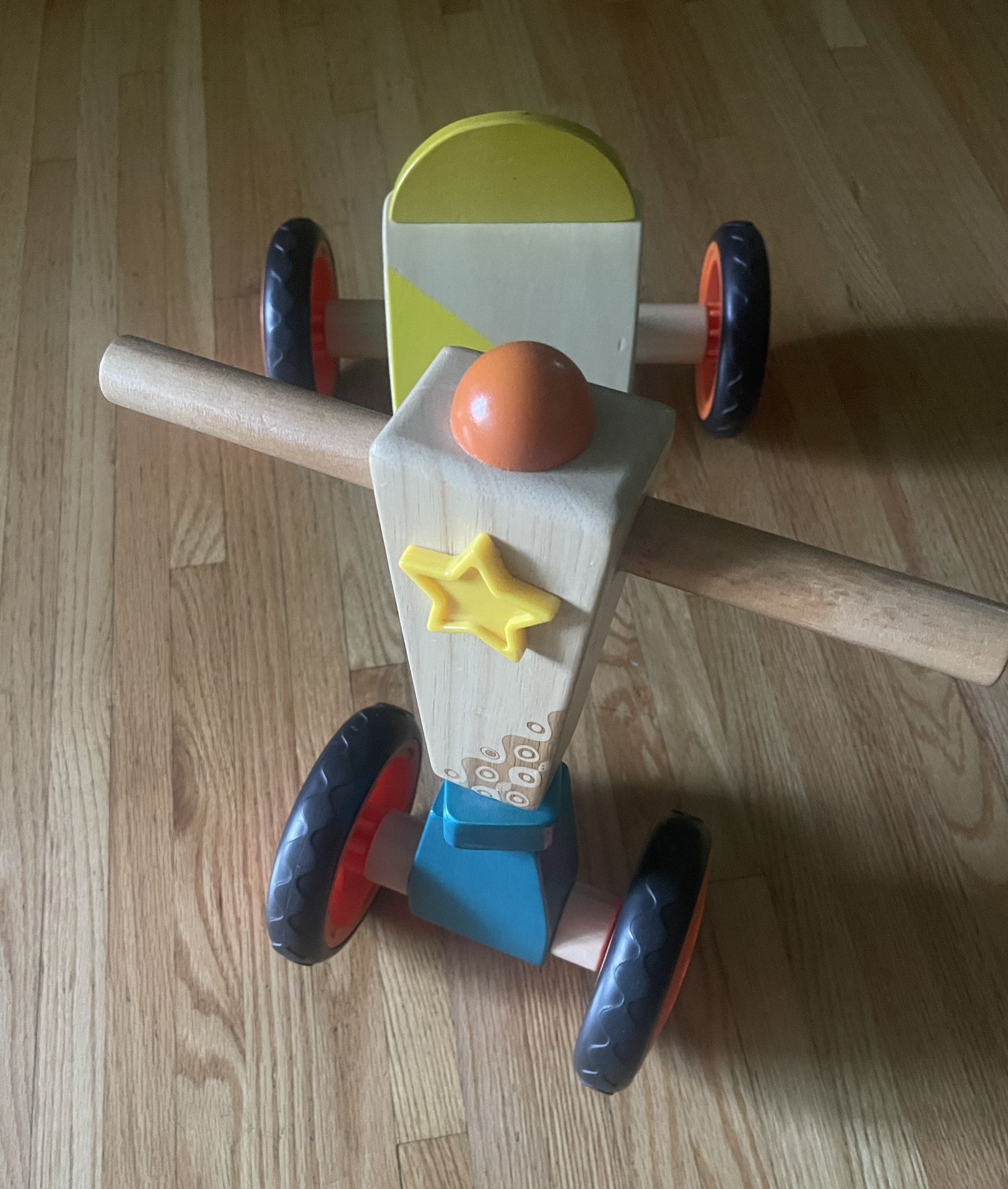Wooden toddler ride-on toy with 4 wheels