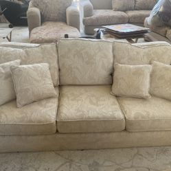 Off-white couch and oversize chair