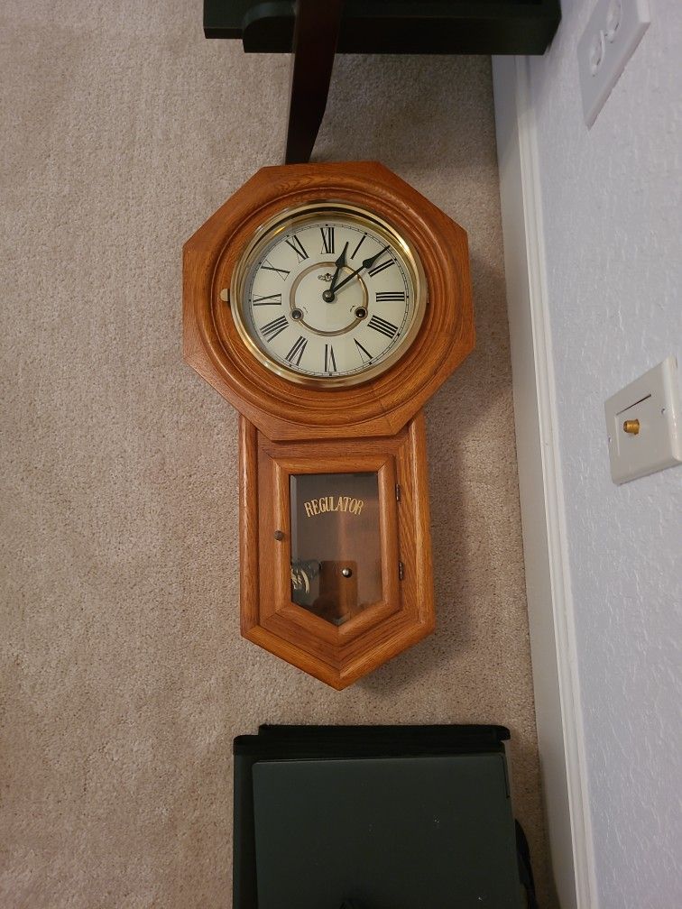 D AND A CLOCK WITH PENDULUM