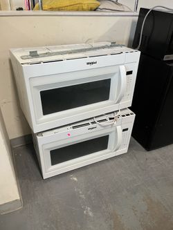 Above stove white whirlpool microwave (in store)