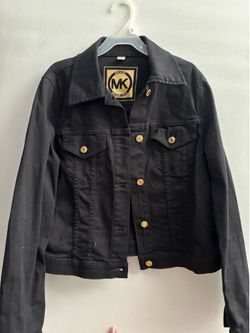Women’s black Michael Kors denim trucker jacket featuring gold-tone hardware and a prominent interior logo patch.