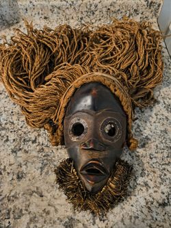 Handcrafted Dan-style African mask made of wood and jute fiber