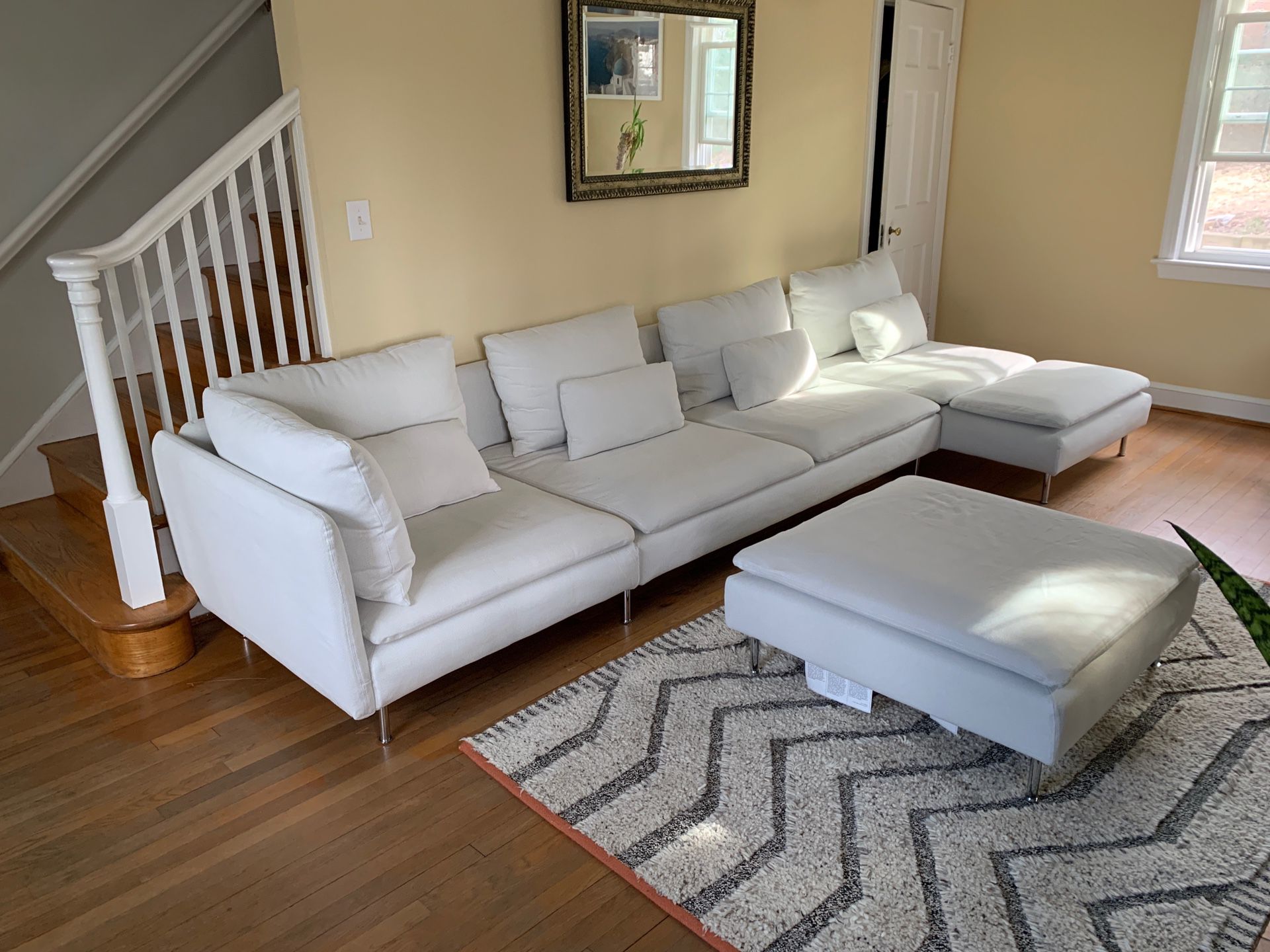 IKEA white fabric sectional couch with ottoman and pillows