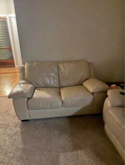 Beautiful cream colored leather loveseat.
