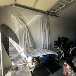 Two Foam Surf Boards One Is White and 6ft Tall And The Other Is Blue And 8ft Longboard 