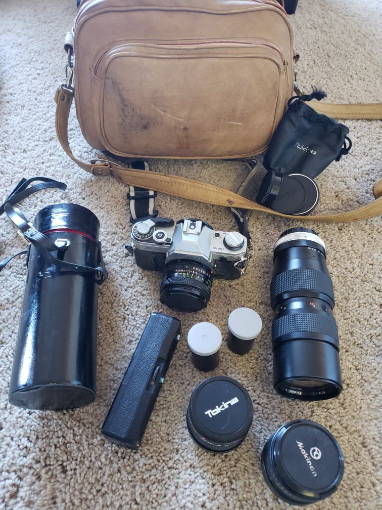 Canon AE1 film camera with several lenses and power winder