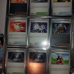 Binder full of pokemon cards and a few  tokens.