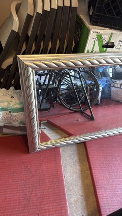Beautiful silver trimmed wall mirror .