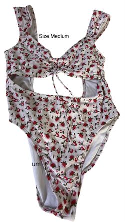 Xhilaration one-piece swimsuit with a white floral print and a cinched cut-design. Size MEDIUM