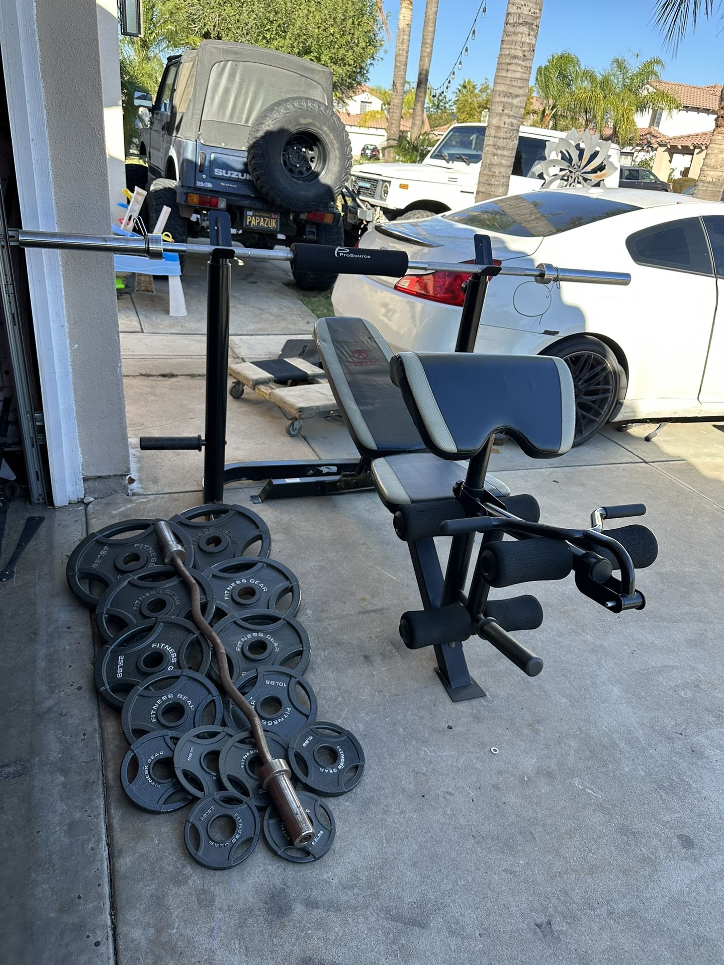 Bench press/squat rack with 7ft 45lbs bar plus 255lbs of Olympic weights and curl bar