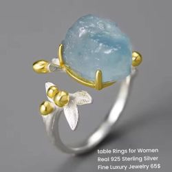 A unique sterling silver ring plated with gold and featuring a natural aquamarine stone.
