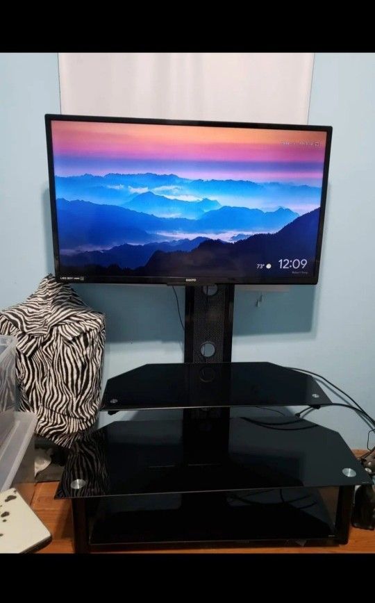 2 Flat Screen TV's with 1 Black Glass Tv Stand