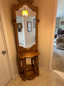 oak hall tree featuring a large mirror and distinctive carved lion figures