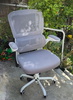 Logicfox ergonomic mesh office chair with flip-up arms.
