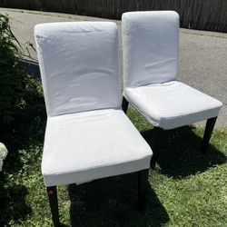 Two chairs with white washable covers