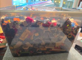Assorted legos, bits, bricks, pieces, and a bag of People and accessories