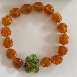 Unique and striking design:  amber like beads with a beaded floral centerpiece