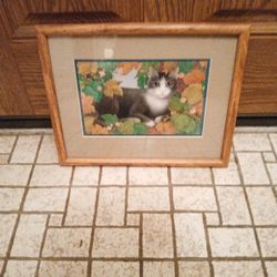 Framed Artwork Print Of A Cat Surrounded by Leaves 