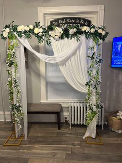 Gold Wedding Arch with Floral Decor and Draping