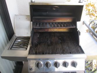 Ducane 4-burner stainless steel gas grill and a side burner and rotisserie system