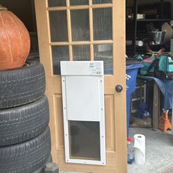Dog Door Electric  And Door Is Like New still has the plastic on the glass