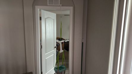 Baby jumper hangs from door frame