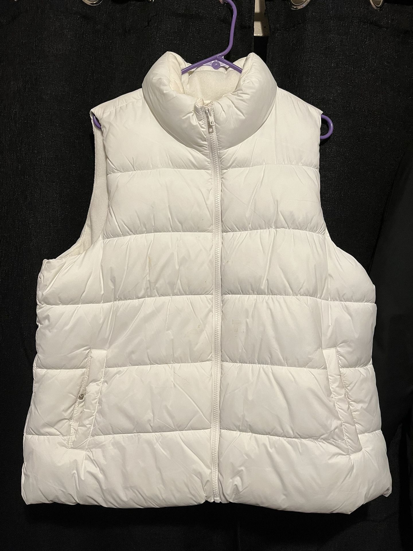 white puffer vest , black jacket with fur around hoodie.