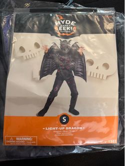 LIGHT-UP DRAGON - Jumpsuit • Mask • Wings Other accessories shown sold separately WARNING: CHOKING HAZARD -Small parts. Not for children under 3 years