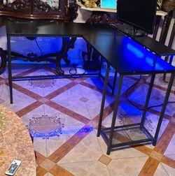 Black desk with LED lights, like new.