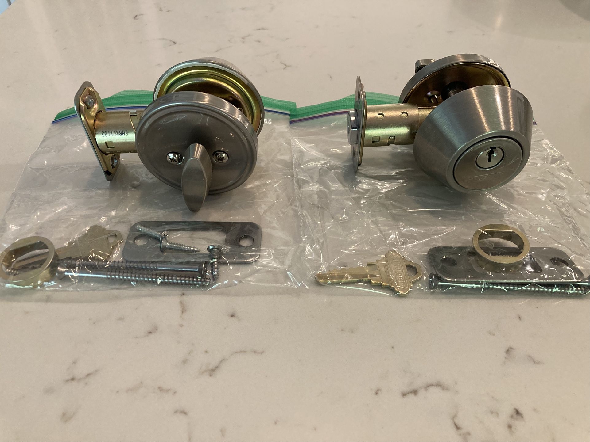two Schlage single cylinder deadbolts