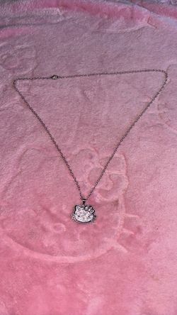 Hello kitty necklace and bracelet with charms.
