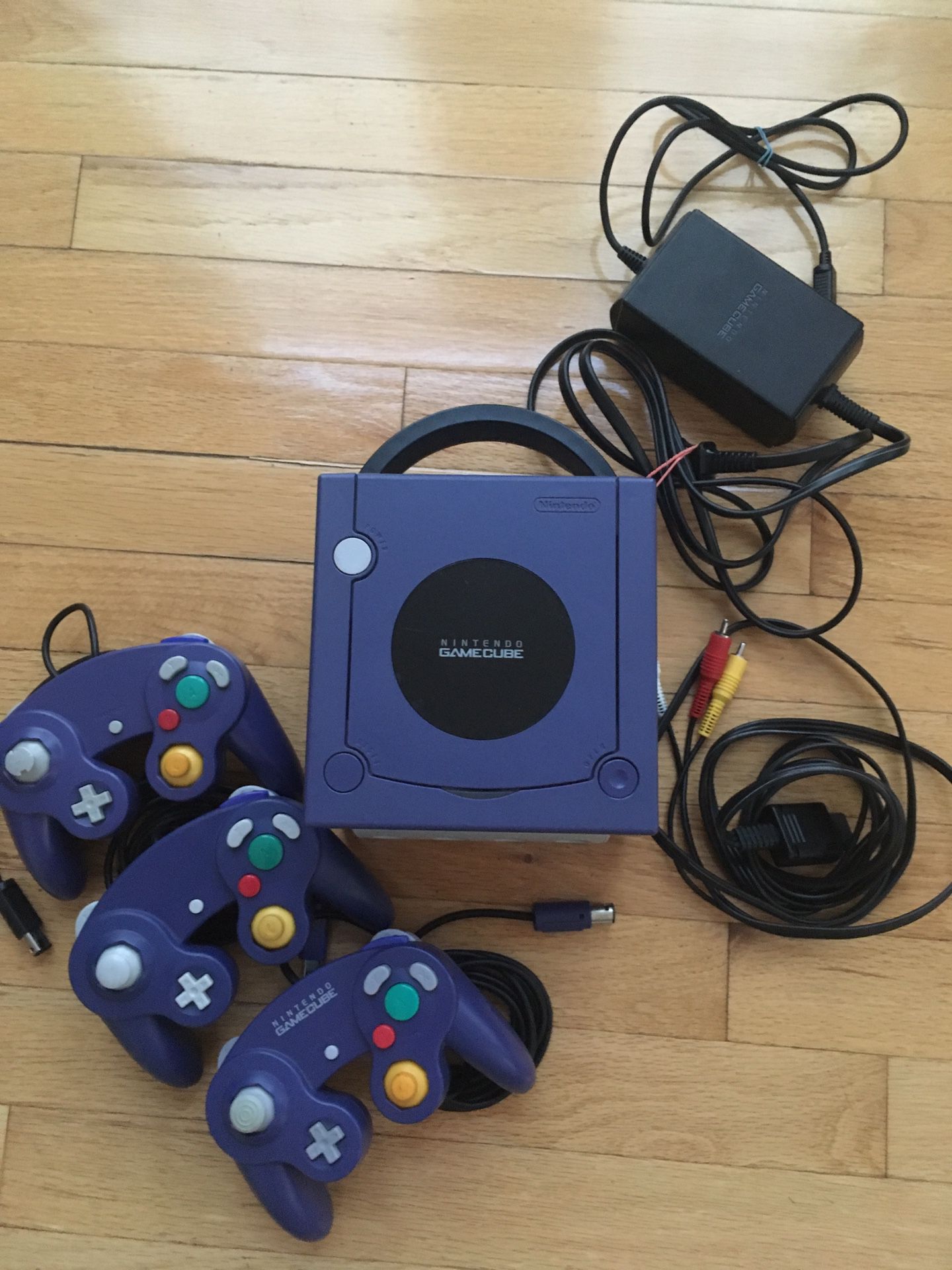 GameCube console, charger, audio visual cable, and 3 controllers