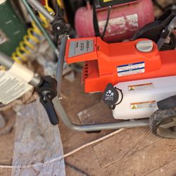 Powerwasher with sprayer attachment.