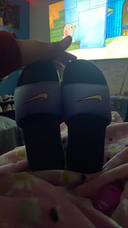 Blue and black Nike slides