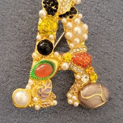 letter A ornate brooch 