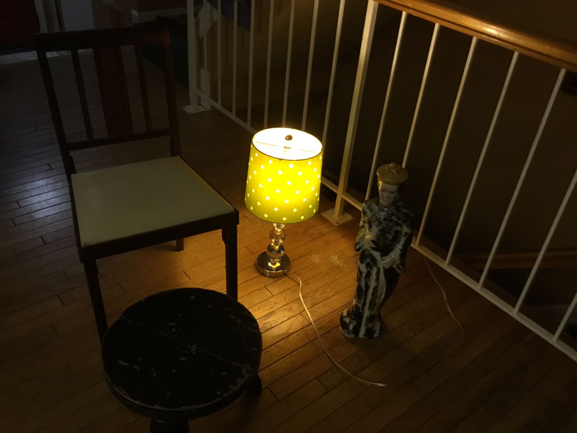 A Nice Ikea Lamp , An Old Fashioned , Vintage , Folding Chair ,an Asian Lady, An Asian Stool Just Gorgeous